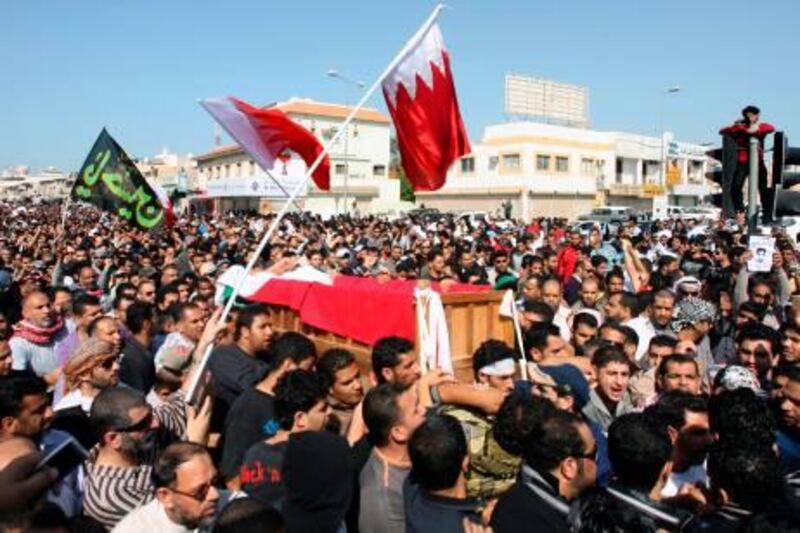 Bahraini Shiite protesters carry the coffin of a comrade who died a day earlier from his wounds following clashes with police, during his funeral in the town of Jidhafs, near the capital Manama, on February 15, 2011. AFP PHOTO/ADAM JAN