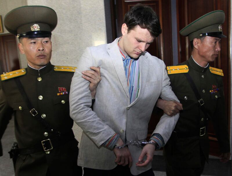 American student Otto Warmbier is escorted by guards at the Supreme Court in Pyongyang, North Korea. AP