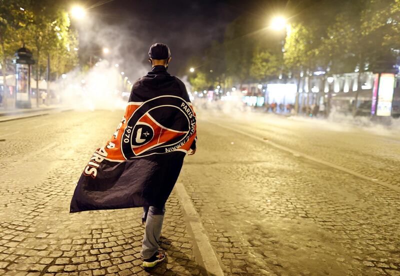 A Paris Saint-Germain supporter on the Champs-Elysees. EPA