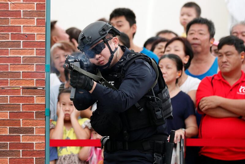 Police take part in a simulated gunmen attack demonstration for the public at a housing estate in Singapore December 10, 2017. Picture taken December 10, 2017. REUTERS/Edgar Su