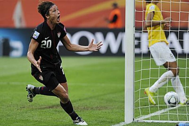 Abby Wambach, the US striker, celebrates her injury time equaliser against Brazil on Sunday which sent the game to a penalty shoot-out.