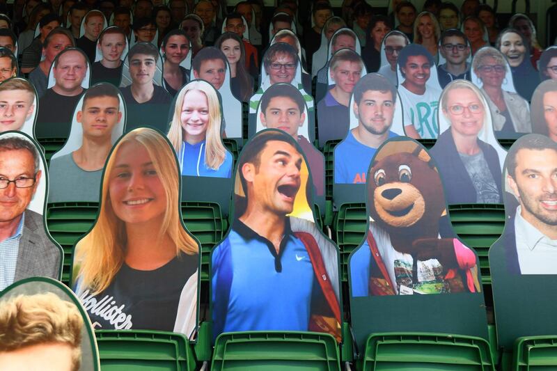 A cardboard cutout of Roger Federer, centre, is among other popular images that filled empty seats before the start of the ATP Championships tournament in Halle, western Germany. AFP