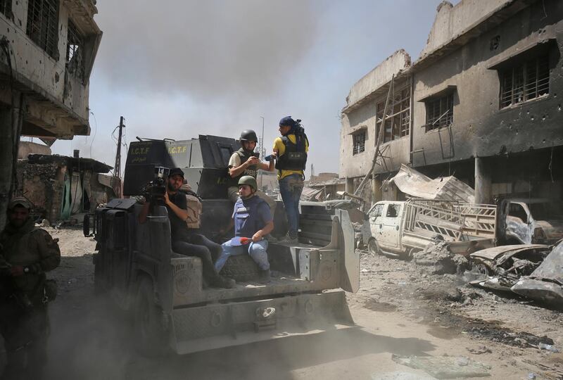 Journalists and TV crews ride in the back of an Iraqi forces humvee in the Old City of Mosul on June 30, 2017, during the offensive to retake the city from Islamic State (IS) group jihadists. - Iraq will declare victory in the eight-month battle to retake second city Mosul from jihadists in the "next few days," a senior commander said on June 30, 2017.
Iraqi forces launched the gruelling battle for Mosul on October 17, 2016, advancing to the city and retaking its eastern side before setting their sights on the smaller but more densely populated west. (Photo by AHMAD AL-RUBAYE / AFP)