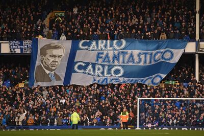 TOPSHOT - Fans unfurl a huge flag of Everton's Italian head coach Carlo Ancelotti in the crowd ahead of the English Premier League football match between Everton and Crystal Palace at Goodison Park in Liverpool, north west England on February 8, 2020. RESTRICTED TO EDITORIAL USE. No use with unauthorized audio, video, data, fixture lists, club/league logos or 'live' services. Online in-match use limited to 120 images. An additional 40 images may be used in extra time. No video emulation. Social media in-match use limited to 120 images. An additional 40 images may be used in extra time. No use in betting publications, games or single club/league/player publications.
 / AFP / Oli SCARFF                           / RESTRICTED TO EDITORIAL USE. No use with unauthorized audio, video, data, fixture lists, club/league logos or 'live' services. Online in-match use limited to 120 images. An additional 40 images may be used in extra time. No video emulation. Social media in-match use limited to 120 images. An additional 40 images may be used in extra time. No use in betting publications, games or single club/league/player publications.
