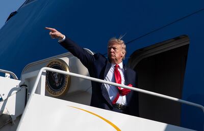 TOPSHOT - US President Donald Trump points as he boards Air Force One at Bangor International airport in Bangor, Maine, on June 5, 2020.  / AFP / NICHOLAS KAMM
