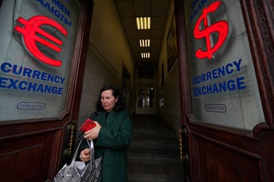 A woman leaves a currency exchange office in St Petersburg, Russia. AP