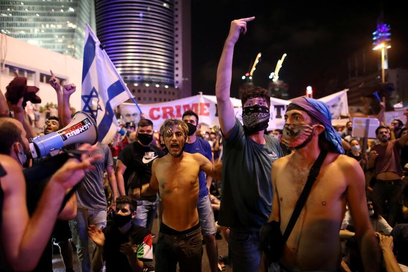 Israelis block a main junction in the city as they protest against the government's response to the financial fallout of the coronavirus crisis in Tel Aviv, Israel. REUTERS