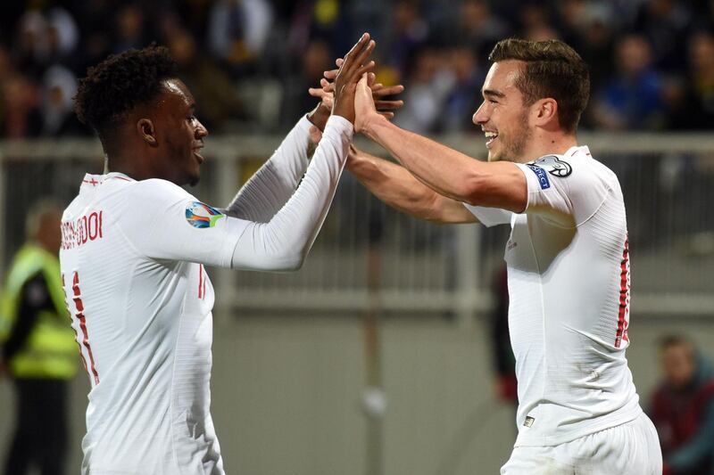 England's midfielder Harry Winks, right, celebrates in Prishtina. AFP