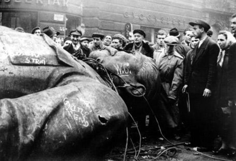 People gather around a fallen statue of Joseph Stalin in front of the National Theater in Budapest, Hungary, on October 24, 1956.