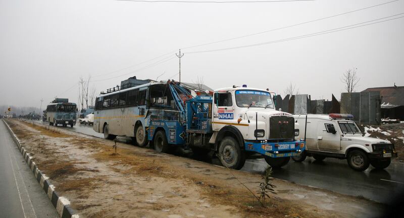 A tow truck takes away a damaged Central Reserve Police Force (CRPF) vehicle near the site blast in Lethpora area of  south Kashmir' s Pulwama  district some 20 kilometers from Srinagar, the summer capital of Indian Kashmir.  EPA