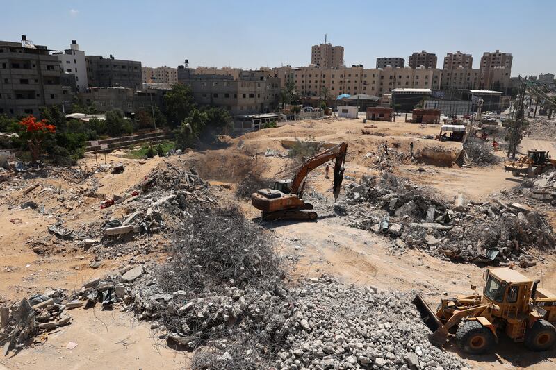 Palestinian workers clear the rubble of buildings in Beit Lahia in the northern Gaza Strip. AFP