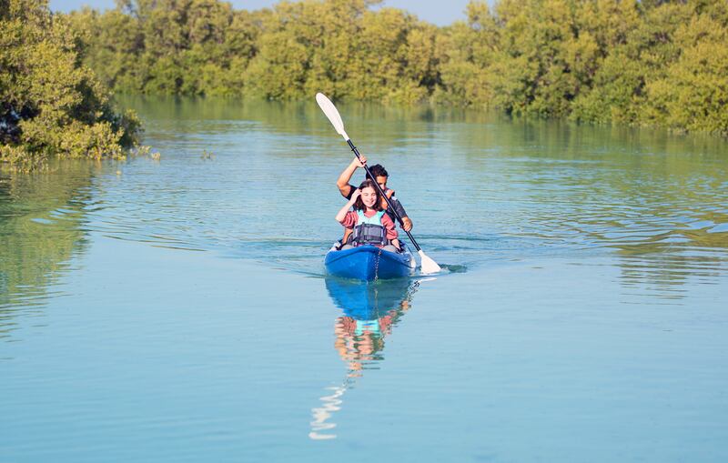 Clara kayaks through the mangroves.