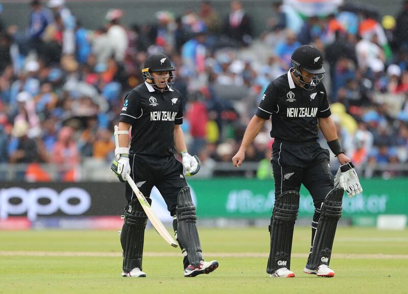 New Zealand's Ross Taylor, right, and Tom Latham leave the field after rain stopped play during the Cricket World Cup semi-final match between India and New Zealand at Old Trafford in Manchester, England, Tuesday, July 9, 2019. (AP Photo/Aijaz Rahi)