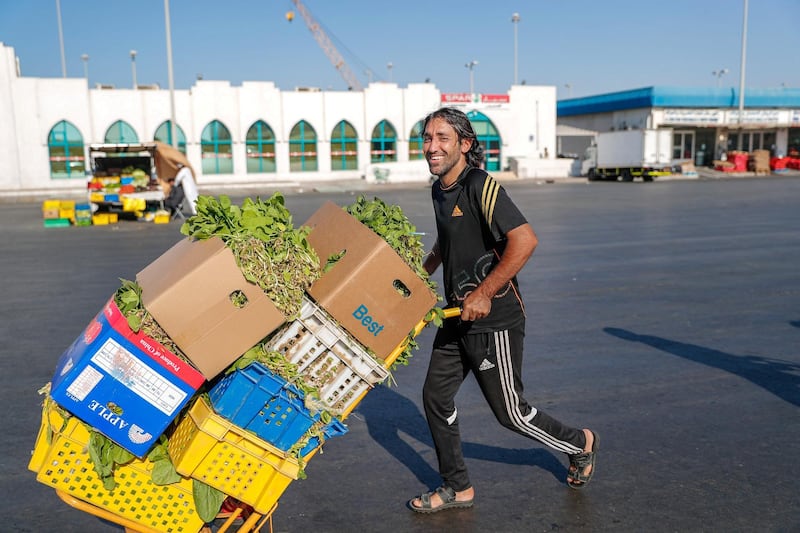 Abu Dhabi, U.A.E., January 5, 2018.  The Abu Dhabi Fruits and Vegetable Market at Port Zayed is the main fruit and vegetable market at Abu Dhabi, UAE.  Vegetable delivery man, Mohammed Ibrahim busy at the market before afternoon opening which  usually starts at 3:45-4 p.m..
Victor Besa / The National
Stand Alone for Rob Gurdebeke