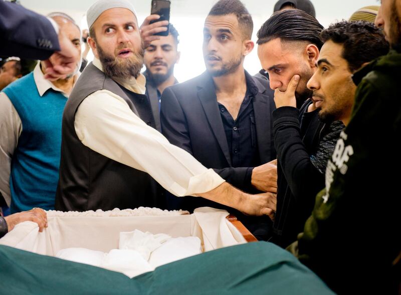 Ali Hassan, second from right, views the wrapped body of his two-year-old son, Abdullah Hassan, at his funeral at the Sacramento Islamic Center on Saturday, Dec. 29, 2018. The toddler died days after a reunion with his mother from Yemen, after a long fight with a degenerative brain disease. He was separated from his mother due to travel restrictions instituted by the Trump Administration. (Autumn Payne/The Sacramento Bee via AP)