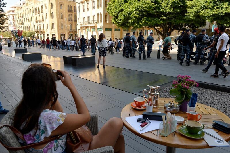 A woman takes pictures from her cell phone during a protest in downtown Beirut, Lebanon.  EPA