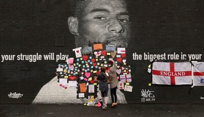 Messages of support are placed on a mural of Marcus Rashford after it had been defaced by racist abuse. AP