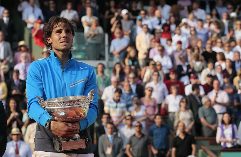 Spain's Rafael Nadal holds his trophy after winning over Switzerland's Roger Federer during their men's final in the French Open tennis championship at the Roland Garros stadium, on June 5, 2011, in Paris.     AFP PHOTO / JACQUES DEMARTHON (Photo by JACQUES DEMARTHON / AFP)
