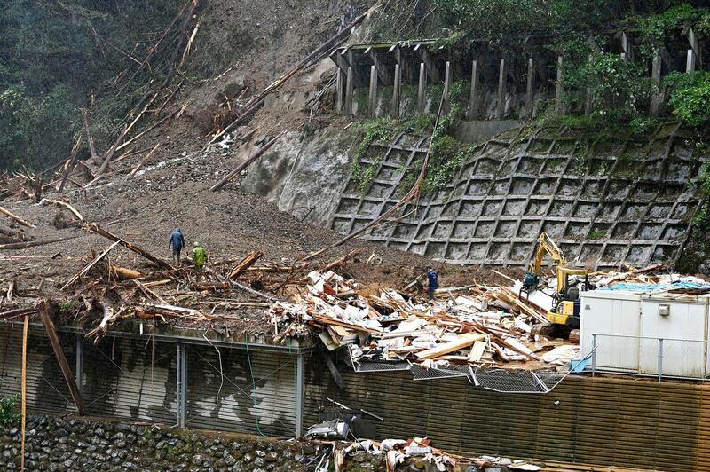 Rescuers work at a landslide site as a typhoon hit Shiiba village, Miyazaki prefecture, southwestern Japan.  AP