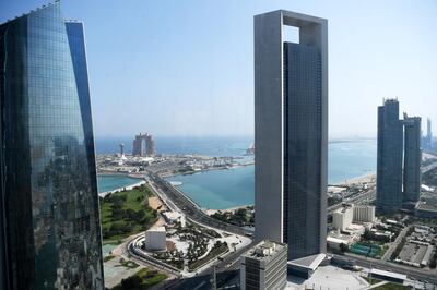 A genral view taken on May 29, 2019 shows the sea front promenade in the Emirati capital Abu Dhabi with the ADNOC headquarters (Abu Dhabi National Oil Company) office complex (C) in the foreground on May 29, 2019. (Photo by Karim SAHIB / AFP)