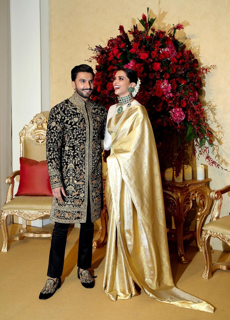 While the couple wore bold red designs at their Italian wedding, they opted for refined gold, black and green for their Indian party.