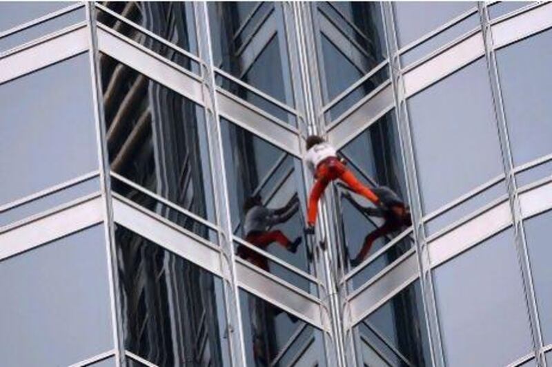 Alain Robert was obliged to wear safety equipment to climb the Burj Khalifa last March. Satish Kumar / The National