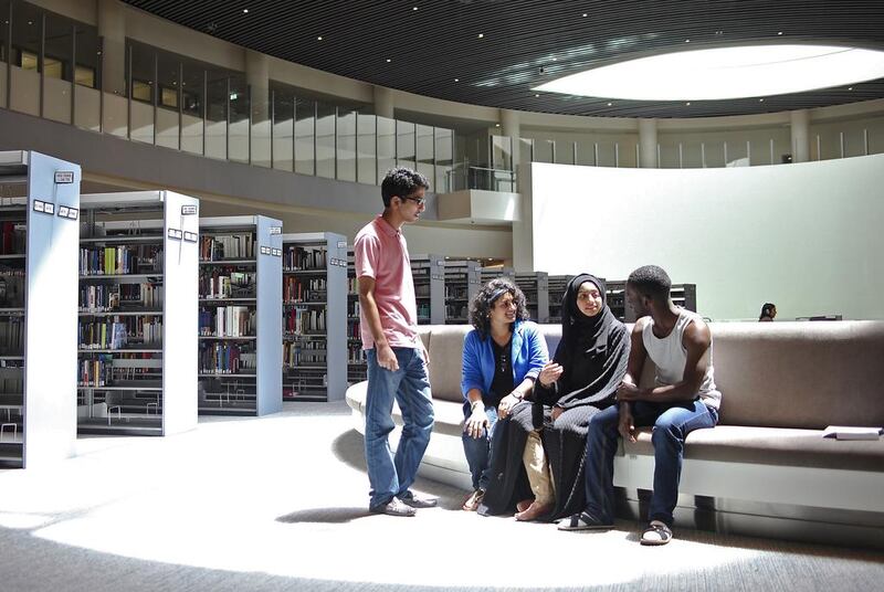 From left, Mohammad Mirza, Sangeetha Mahadevan, Hayat Hassan and Rodger Iradukunda at NYU Abu Dhabi’s library on the first day of term. Lee Hoagland / The National

