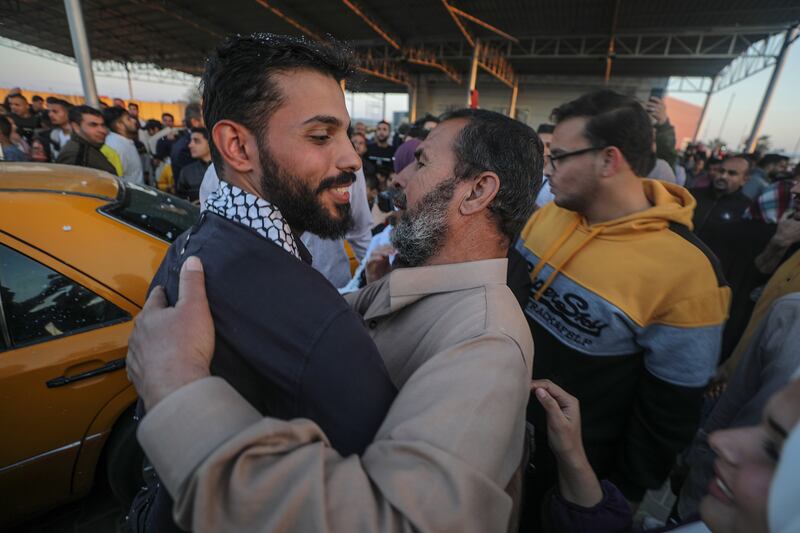 Palestinians greet each other at the Rafah crossing, after fleeing Sudan. EPA 