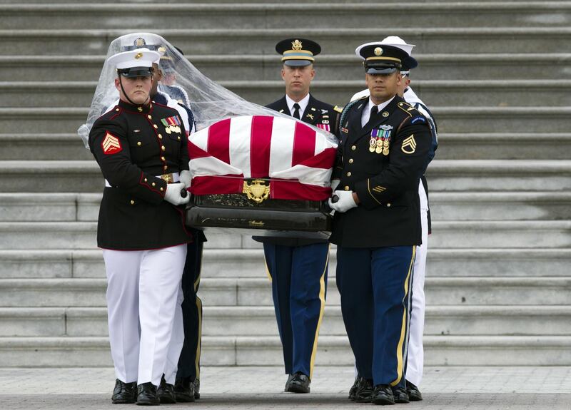 The casket of Senator John McCain is carried to a hearse from the US Capitol. AP