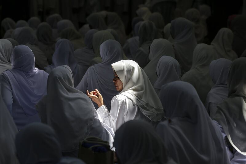 Malaysian Muslim women chat at a mosque in Kuala Lumpur. Ahmad Yusni / EPA