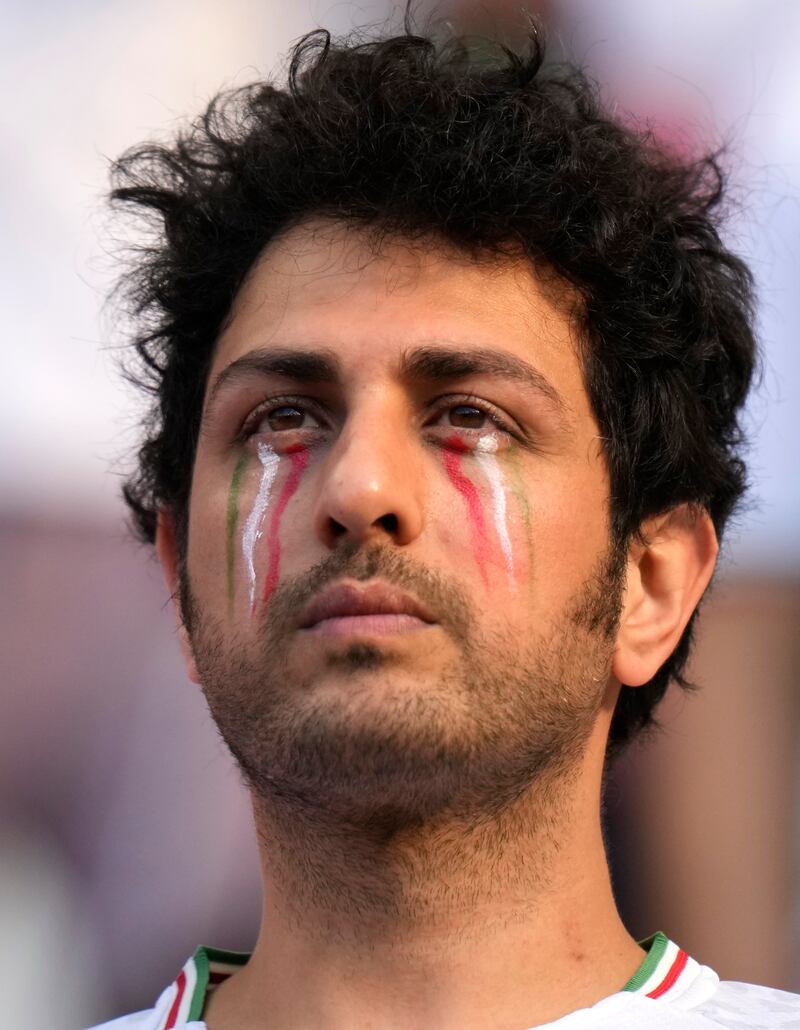 Some Iran fans indulged in pre-match face-painting. AP