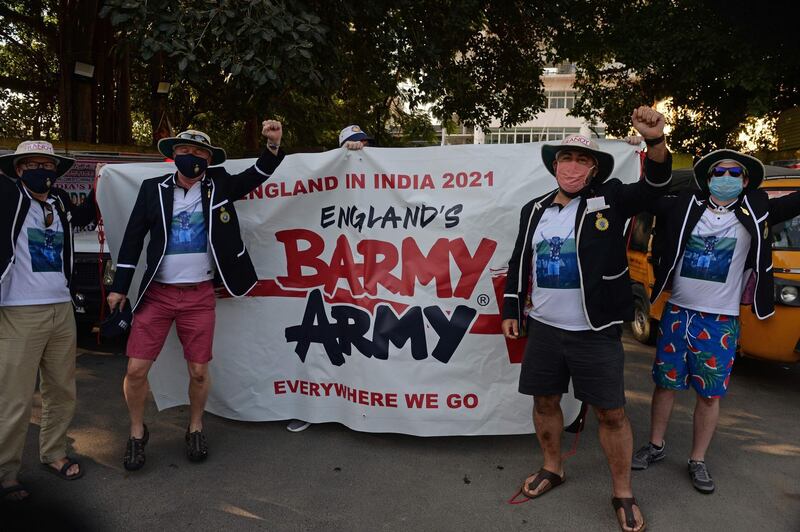 Spectators holding banners cheer before the second Test between India and England outside the M.A. Chidambaram Cricket Stadium in Chennai. AFP