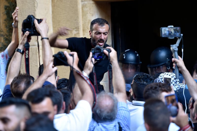 Protesters chant slogans at the Lebanese Ministry of Economy. EPA