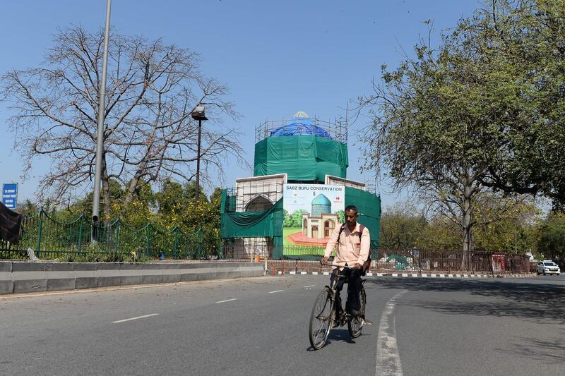 A man cycles along a deserted road in New Delhi.  AFP
