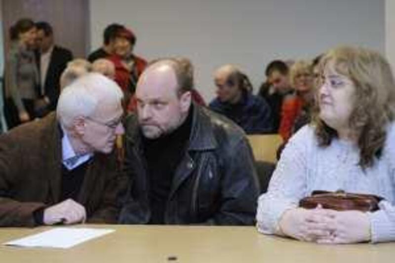 Barbara E. (R), 50 years old former cashier of the supermarket chain Kaiser's, sits besides her lawyers Reinhold Niemerg (C) and Benedikt Hopmann as she waits for her verdict on Februay 24, 2009 in Berlin. Berlin's higher labour court dismissed the woman's appeal against a former verdict that her instant dismissal was legal. Barbara E. was sacked after 31 years by her employer who said that she had embezzled deposit vouchers for bottles worth 1,30 Euros.    AFP PHOTO    DDP/STEFFI LOOS    GERMANY OUT