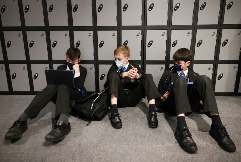 Pupils sit next to lockers at the Fulham Boys School in London. Reuters