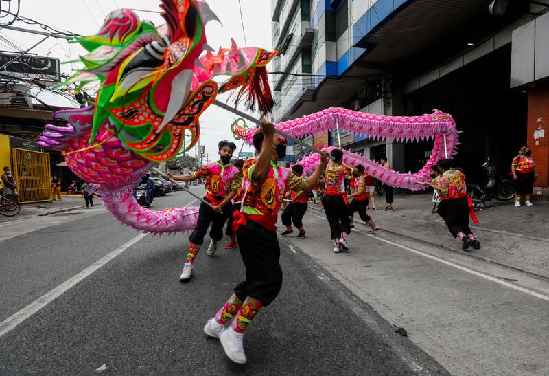 Filipino dragon dancers perform in Manila, where Lunar New Year celebrations were muted despite Covid-19 lockdown protocols being gradually eased.  EPA