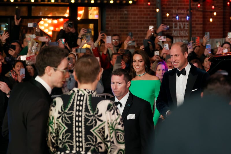 Onlookers try to catch a glimpse of Prince William and Kate as they make their way into the MGM Music Hall. AP