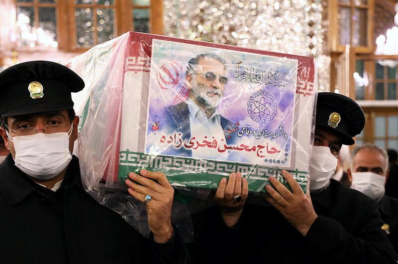 Servants of the holy shrine of Imam Reza carry the coffin of Iranian nuclear scientist Mohsen Fakhrizadeh in Mashhad, Iran. WANA via REUTERS