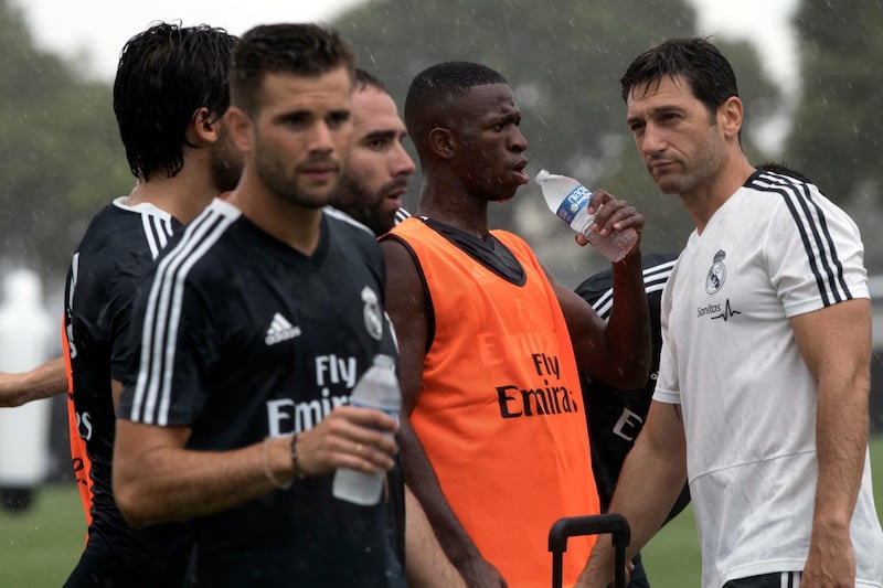 Real Madrid forward Vinicius Junior, centre, drinks in the rain while training in Miami. AP Photo
