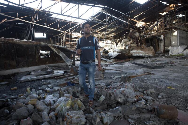 Mohammed Al Wadia, 23, one of the owners of the Gaza-based dairy and food distribution company Wadia & Sons, stands in the company’s warehouse that was destroyed by Israeli shelling last year. Heidi Levine for The National