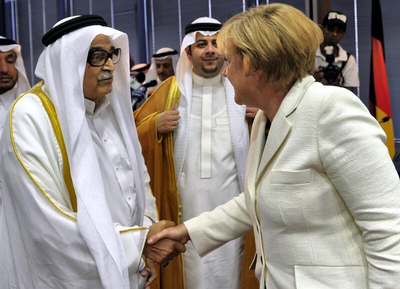 German Chancellor Angela Merkel shakes hands with Saleh Kamel, the head of the Saudi Arabian Chamber of Commerce at his offices on May 26, 2010, in the Red Sea port city of Jeddah. Merkel on a four-nation tour of the Gulf region held talks with Saudi King Abdullah after calling for Gulf nations to help press Iran over its nuclear drive, the official SPA news agency said. AFP PHOTO/AMER HILABI (Photo by AMER HILABI / AFP)