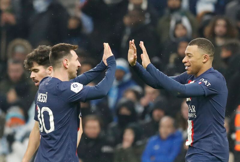 Kylian Mbappe (R) of Paris Saint Germain celebrates with teammate Lionel Messi after scoring the 3-0 lead during the French Ligue 1 soccer match between Olympique Marseille and Paris Saint Germain at the Velodrome Stadium in Marseille, southern France, 26 February 2023.   EPA / SEBASTIEN NOGIER