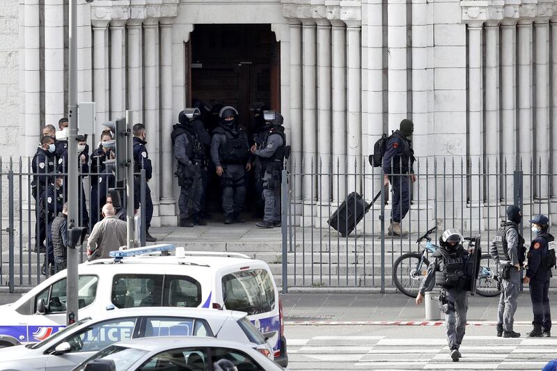 French police officers stand at the entrance of the Notre Dame church. EPA