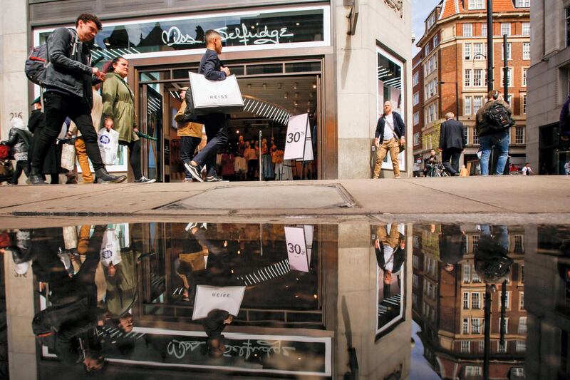 Shoppers carry bags as they pass Miss Selfridge Retail Ltd. fashion retail store on Oxford Street in central London, U.K., on Tuesday, April 17, 2018. While consumers helped drive the economy to a better-than-expected performance last year, spending was still the weakest in six years. Photographer: Luke MacGregor/Bloomberg