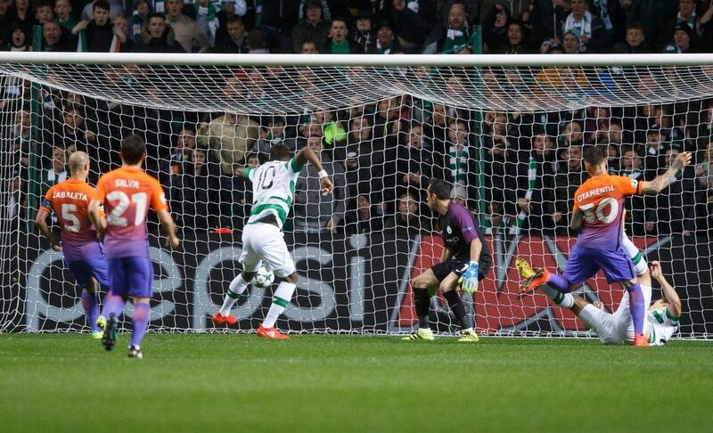 Celtic’s Moussa Dembele, centre, scores the first goal against Manchester City. Robert Perry / EPA