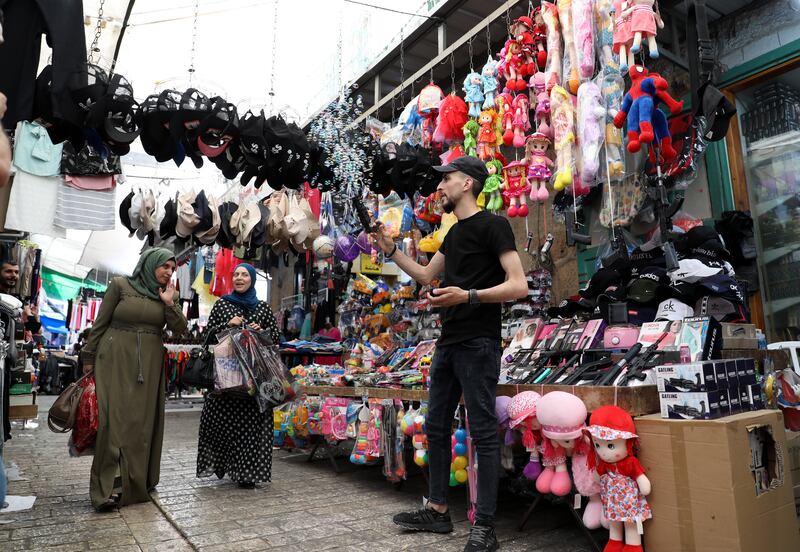 Palestinians shop for toys before Eid Al Adha at a market in the West Bank city of Hebron. EPA