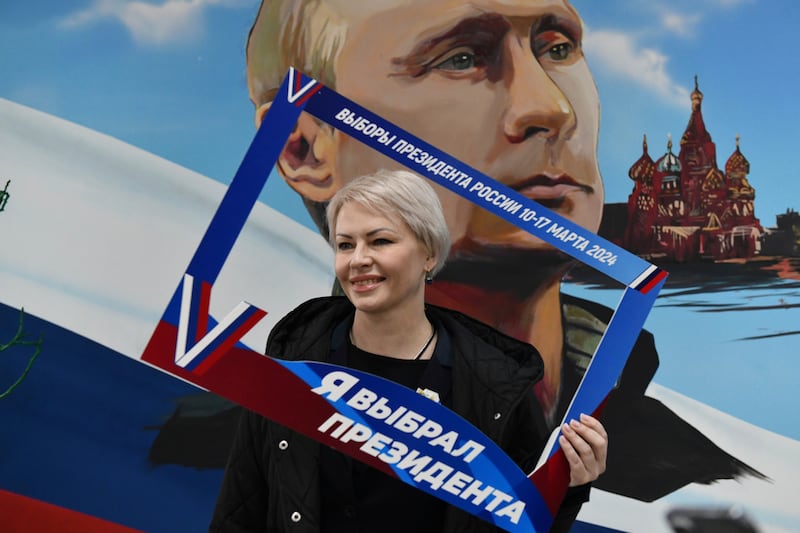 A woman poses with a frame that reads 'I have chosen the president', after voting in the Russian-controlled Donetsk region of eastern Ukraine. AP