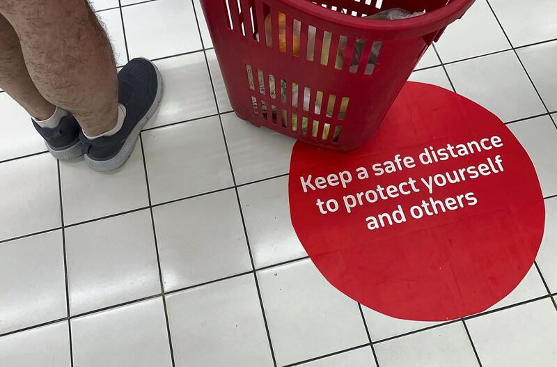 DUBAI, UNITED ARAB EMIRATES , March 23 – 2020 :- Distance stickers pasted on the floor to stay safe as a preventive measure against coronavirus at the Carrefour supermarket in Ibn Battuta mall in Dubai. (Pawan Singh / The National) For News/Online/Instagram. 
