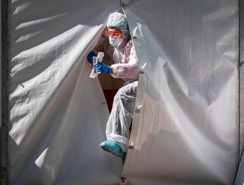 A medical staff gets out from a tent of a testing point for the COVID-19 coronavirus in central Moscow on May 2, 2020.
  Russia on Saturday reported its largest increase in coronavirus cases with the new infections rising by nearly 10,000 in a single day. / AFP / Yuri KADOBNOV
